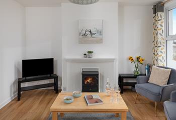 The living area has contemporary furniture and a tasteful use of colour.