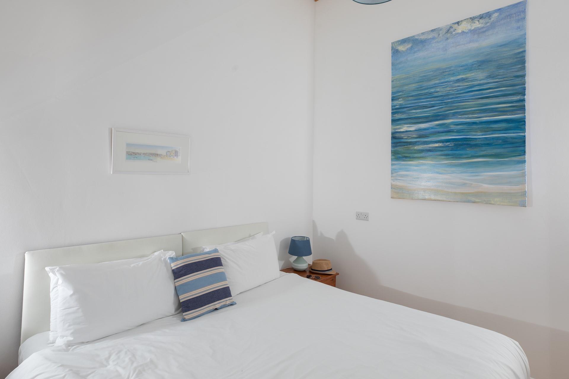 With its soothing, minimalistic design, the comfortable bedroom promises a blissful night's sleep.