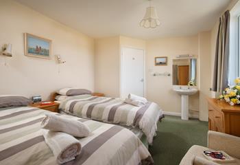 Bedroom 2 has twin beds, ideal for children and teenagers to drift off after memorable days.