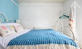 The sky blue wall adds a pop of colour to the bedroom. - Thumbnail Image