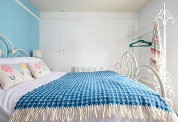 The sky blue wall adds a pop of colour to the bedroom.
