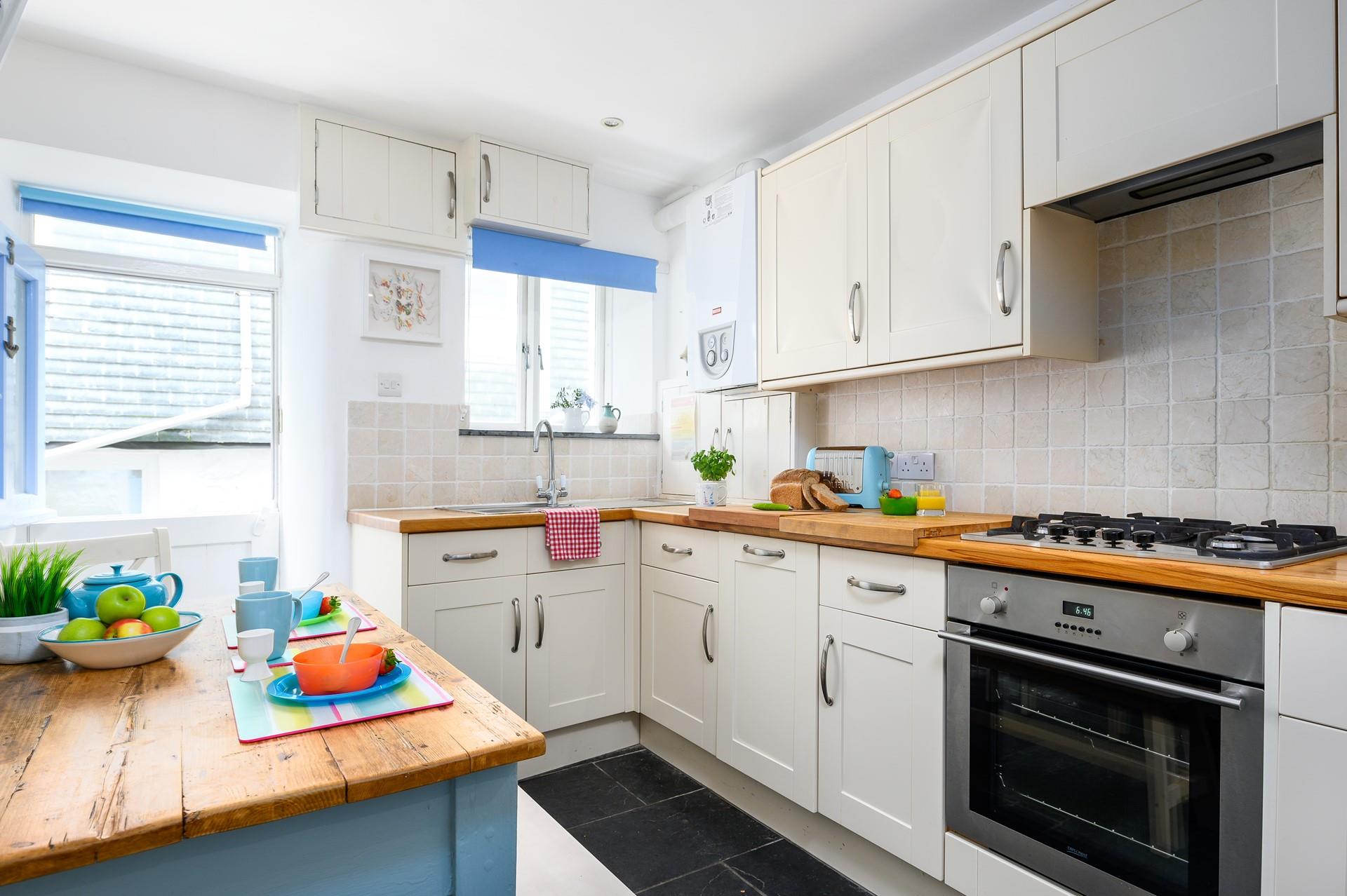 The kitchen is modern and fully equipped for preparing and cooking tasty feasts.