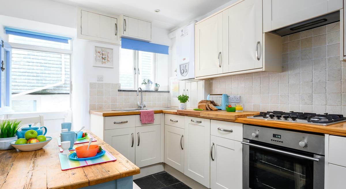 The kitchen is modern and fully equipped for preparing and cooking tasty feasts.