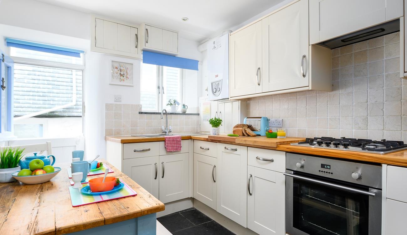 The kitchen is modern and fully equipped for preparing and cooking tasty feasts.