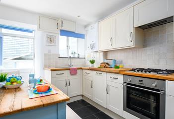 The kitchen is modern and fully equipped for preparing and cooking tasty feasts.