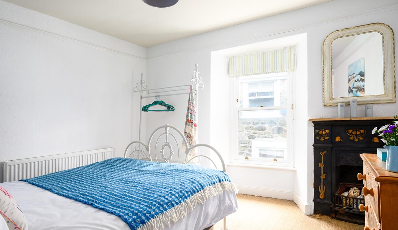 The bedroom has traditional features such as the original feature fireplace in the bedroom.