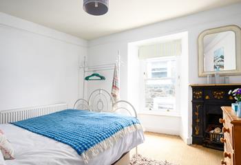 The bedroom has traditional features such as the original feature fireplace in the bedroom.