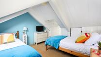 The attic room has twin beds for snuggling up after days spent adventuring.