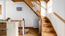 Climb the stairs to bed after a busy day exploring the Cornish coastline.