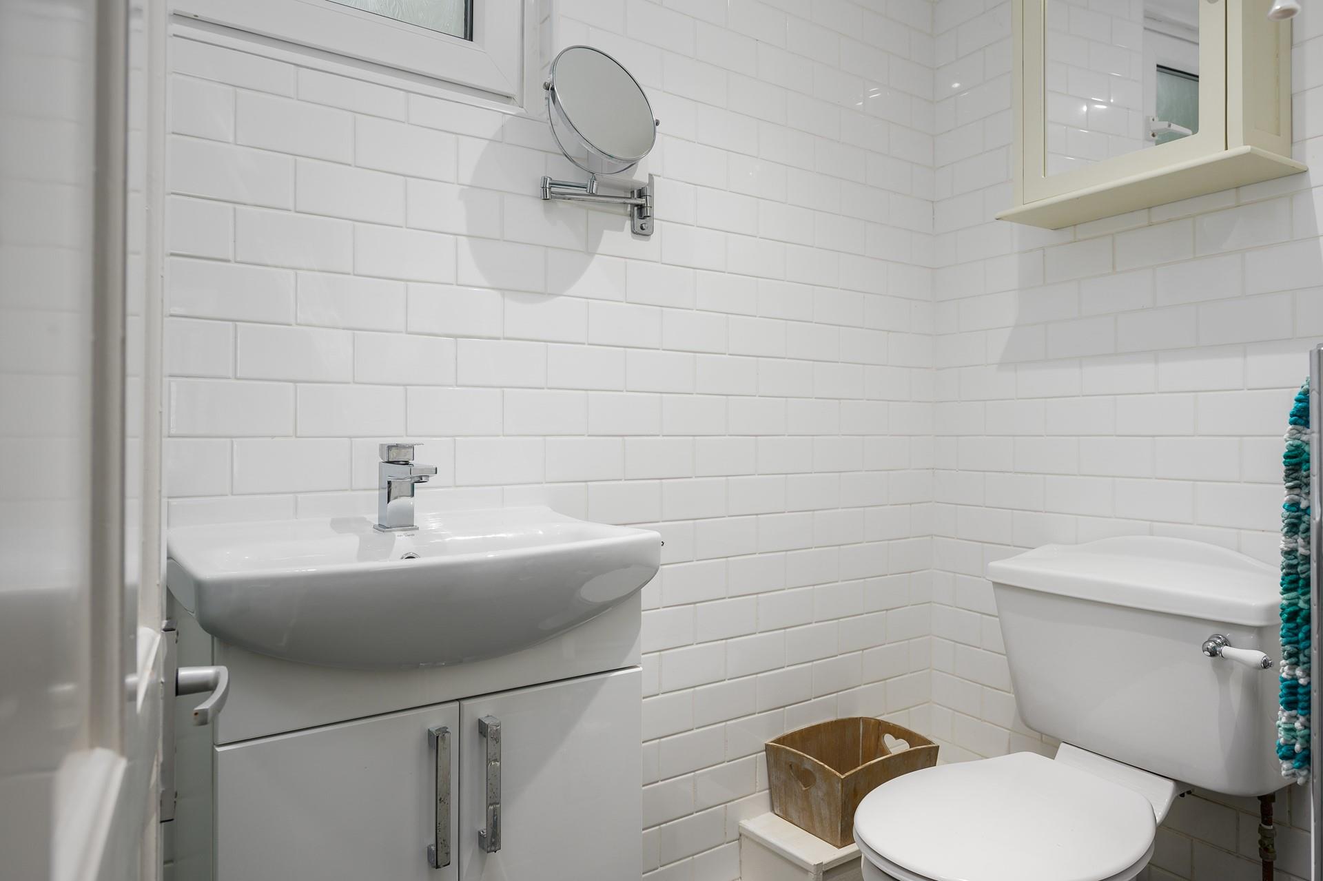 The shower room has a basin, WC and a shower enclosure. 