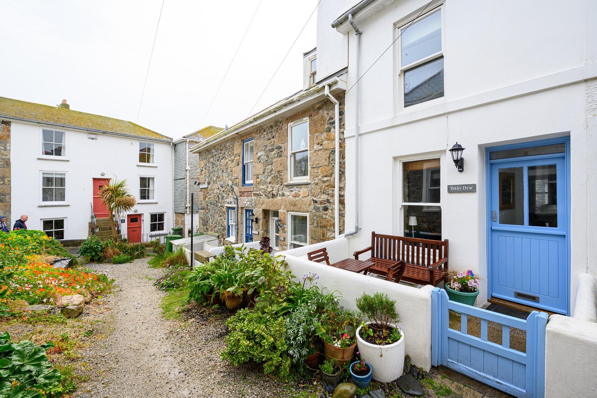 There is an enclosed courtyard with a table, two chairs and a bench a quiet location perfect for a little read.