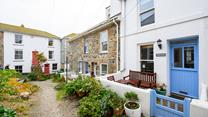 There is an enclosed courtyard with a table, two chairs and a bench a quiet location perfect for a little read.