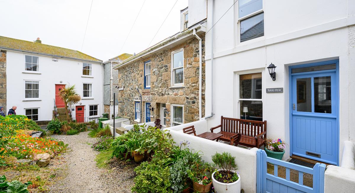 There is an enclosed courtyard with a table, two chairs and a bench a quiet location perfect for a little read.