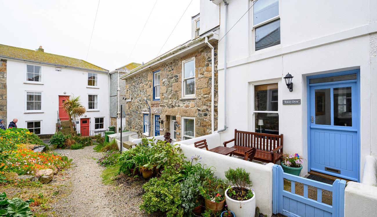 There is an enclosed courtyard with a table, two chairs and a bench a quiet location perfect for a little read.