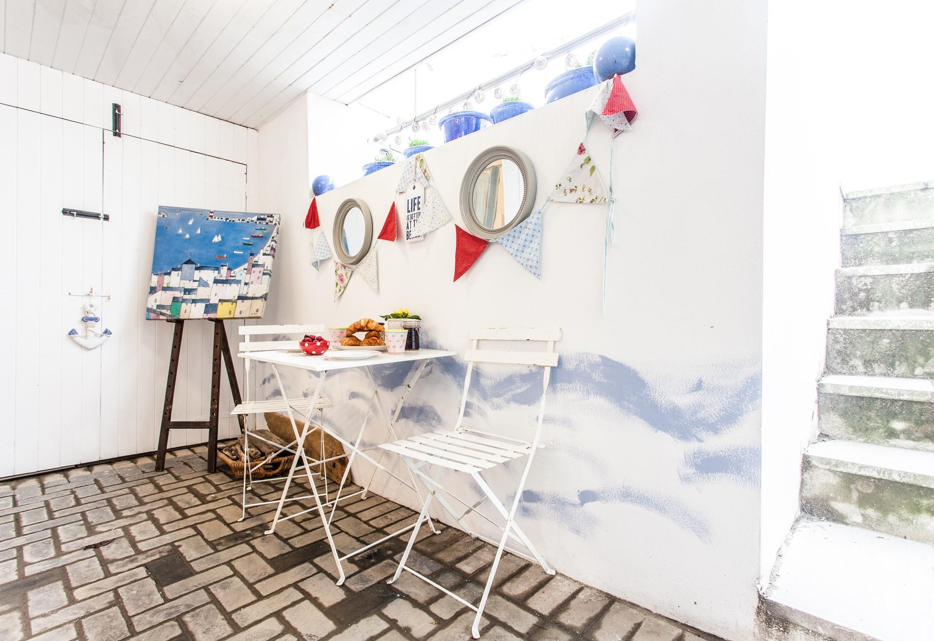 The patio's fun decor will make you feel as though you have been transported straight to the seaside!