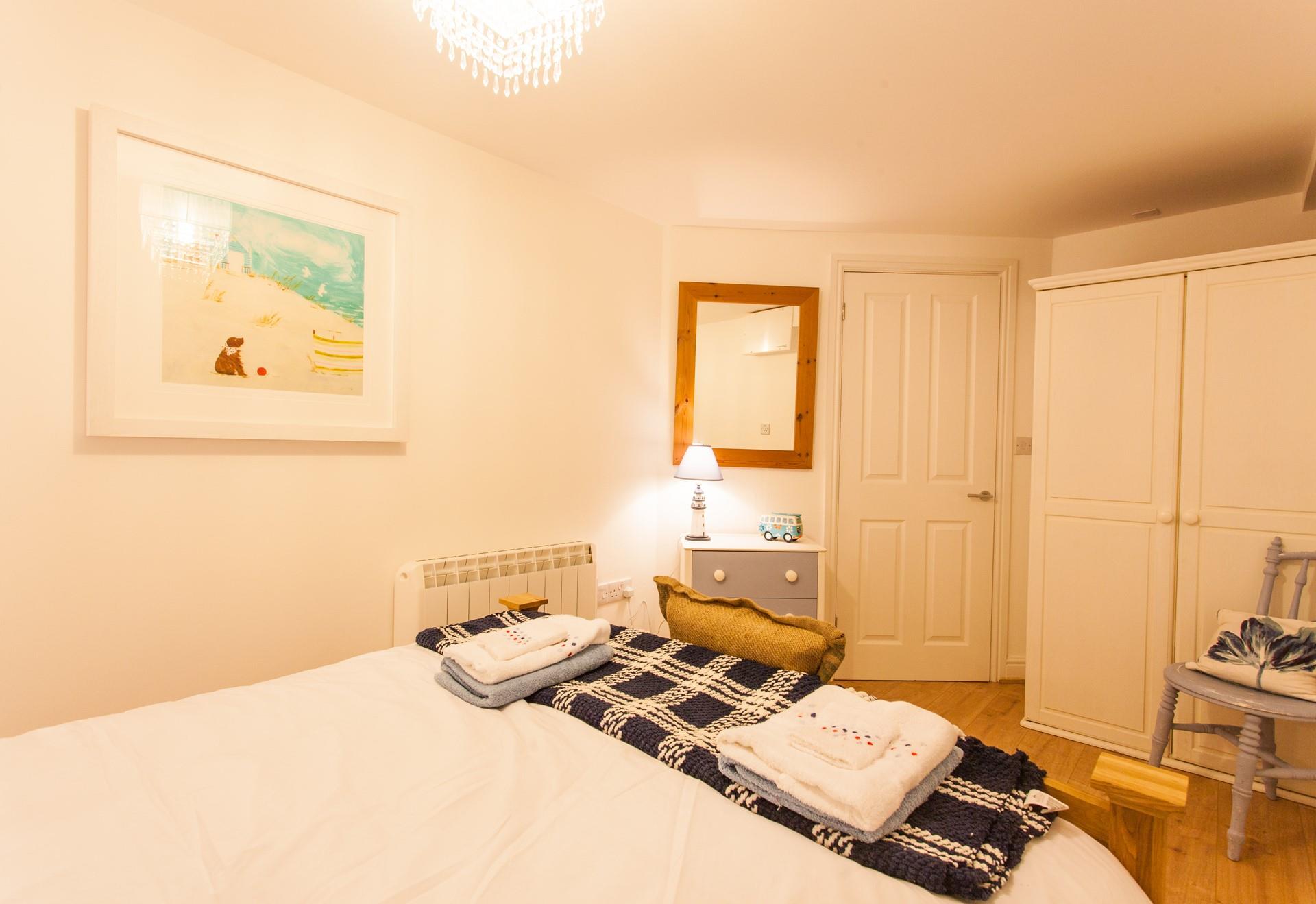 Decorated in hues of cream and blue, the bedroom offers a soothing and stylish space to unwind after a busy day.