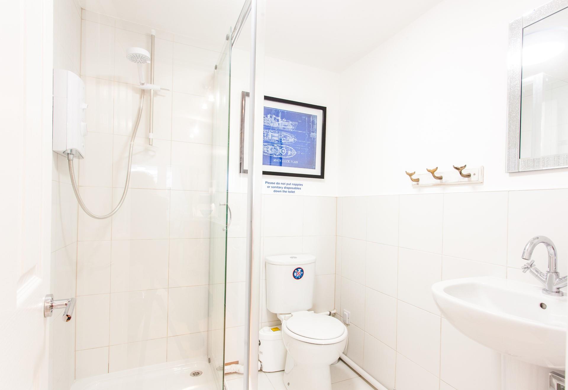 Bright and uncluttered, start your day with an invigorating shower in the bathroom.