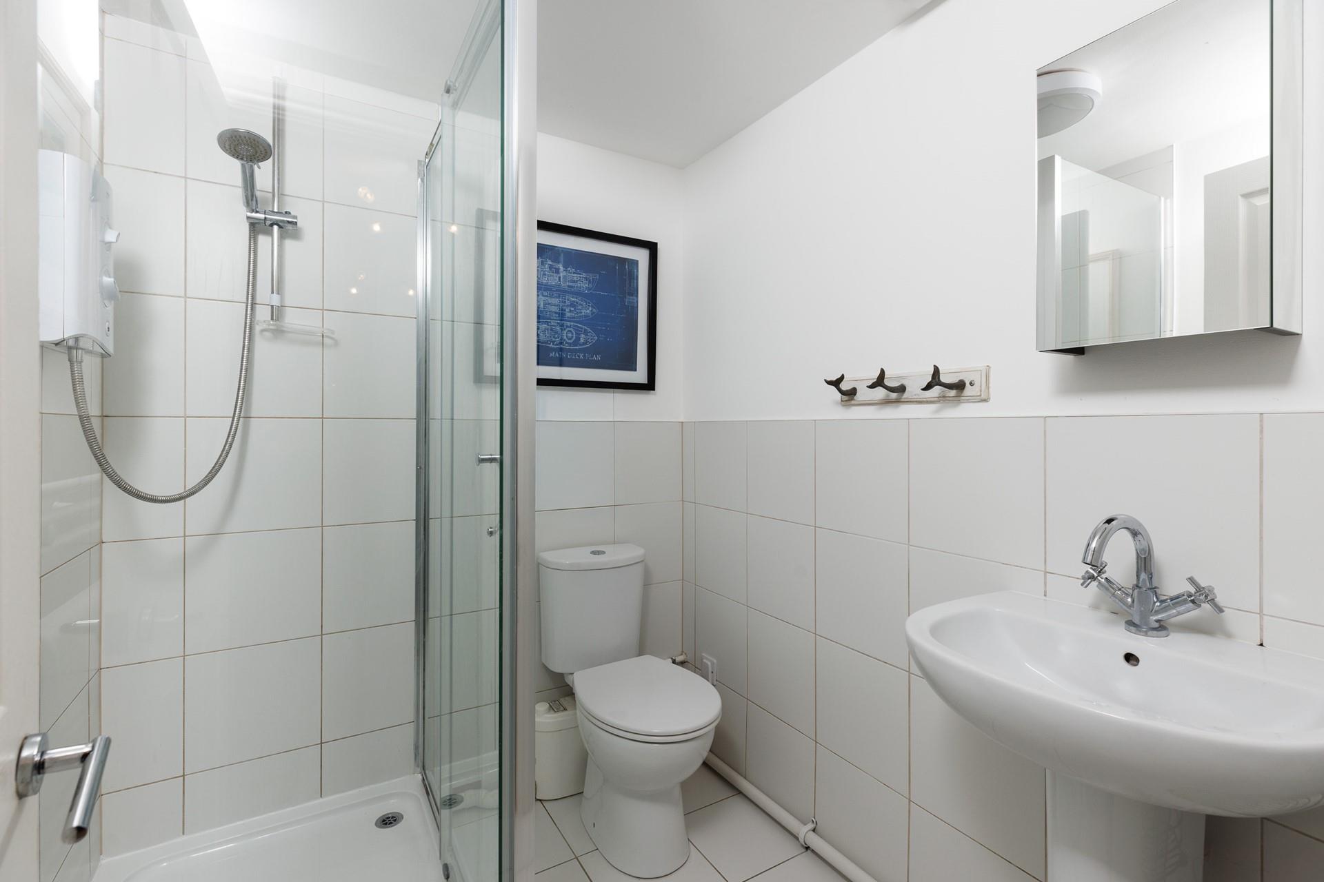 Bright and uncluttered, start your day with an invigorating shower in the bathroom.
