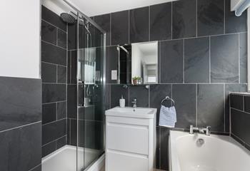 A monochromatic colour palette and modern fixtures have created a stylish space for an invigorating morning shower or to freshen up before dinner!