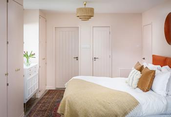 The pale hues create a room of calm to rest your head at night.