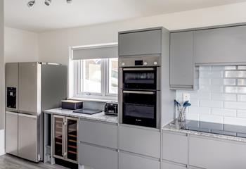 The stylish kitchen features a large American fridge freezer with an ice machine dispensing cubed and crushed ice!