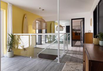 The entrance hallway features statement furnishings and leads down to the ground floor.