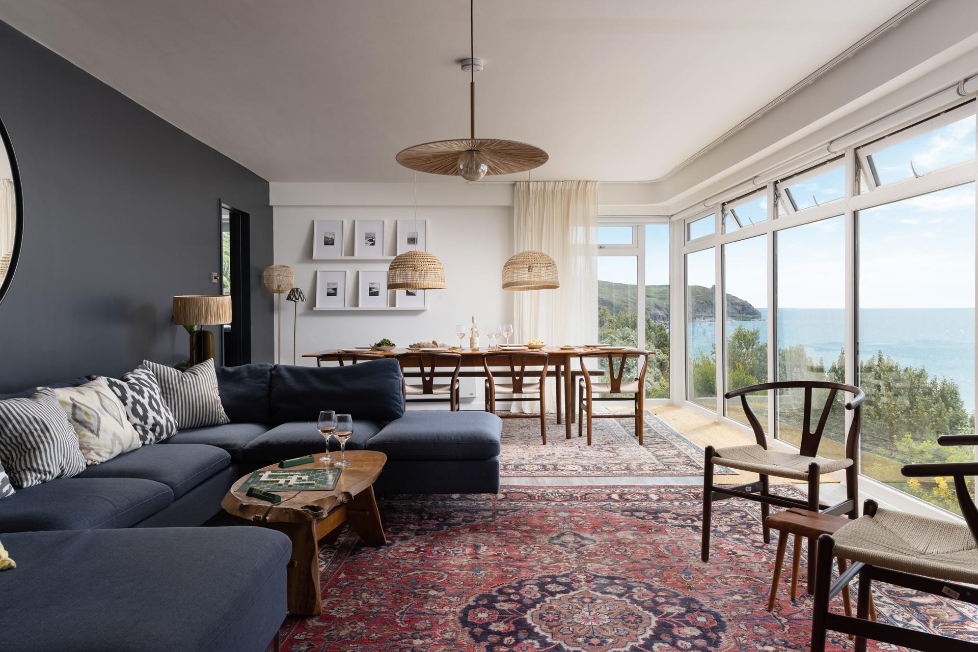 Stylish decor and floor to ceiling windows create a spectacular living space, perfect for dining, socialising, or simply watching the waves.