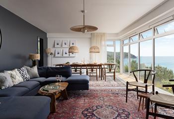 Stylish decor and floor to ceiling windows create a spectacular living space, perfect for dining, socialising, or simply watching the waves.