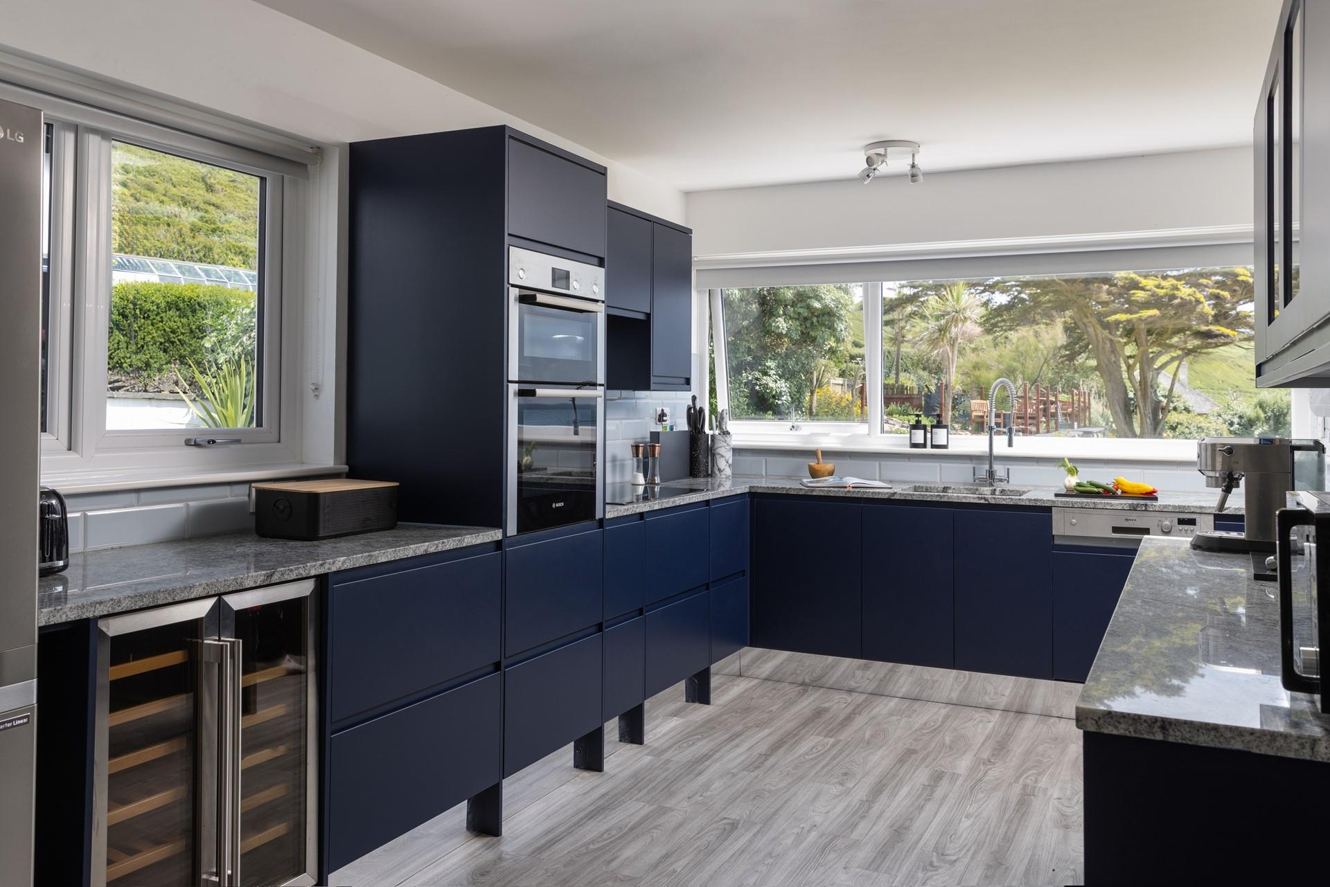 Overlooking the gardens and clifftops, the kitchen is spacious and well-equipped.