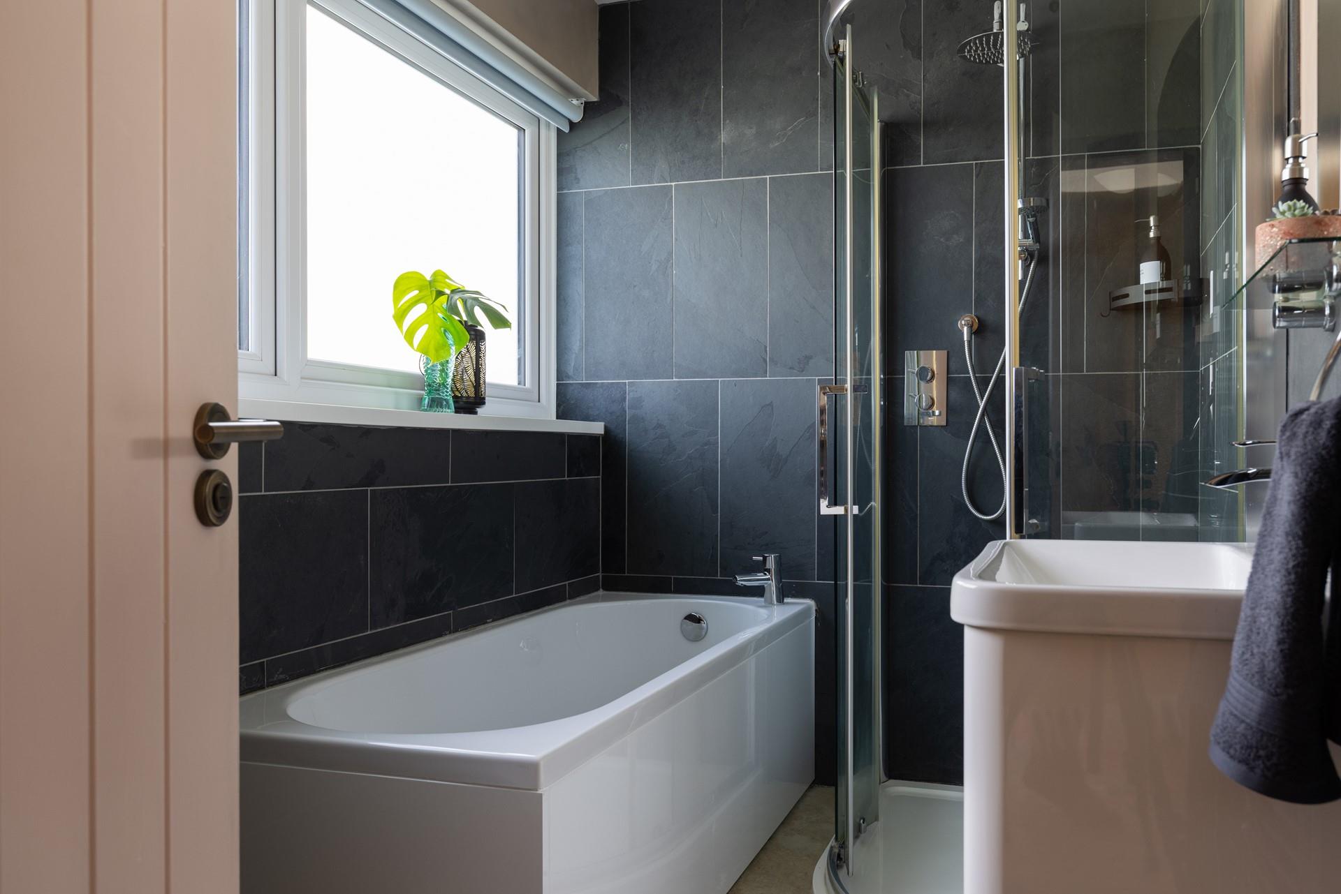 Bedroom 1 has an en suite with a lovely bath, spacious walk-in shower, WC, and basin. 