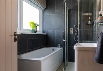 Bedroom 1 has an en suite with a lovely bath, spacious walk-in shower, WC, and basin. 