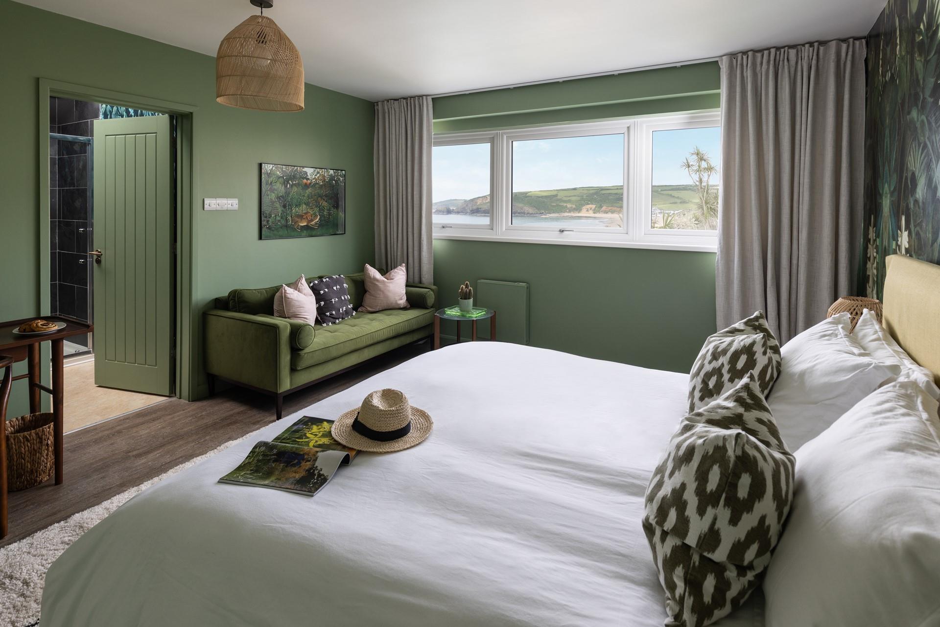 Opulent decor creates a calming space, reflecting the deep greens of the coastal landscape.