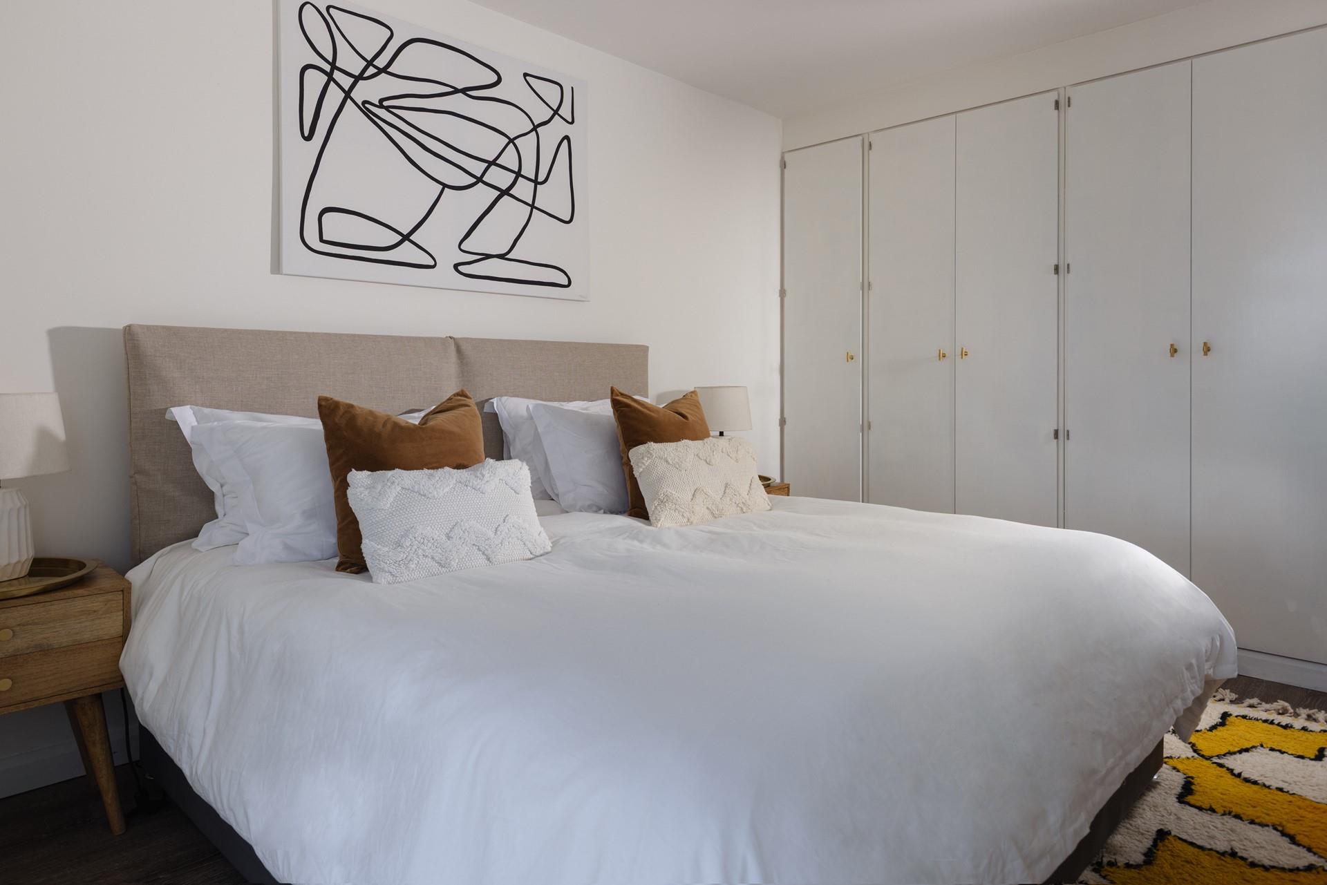 Muted tones and elegant, minimalistic decor have created a haven of relaxation in this bedroom.