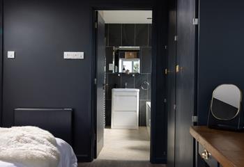 Step into the modern en suite bathroom for a refreshing shower.