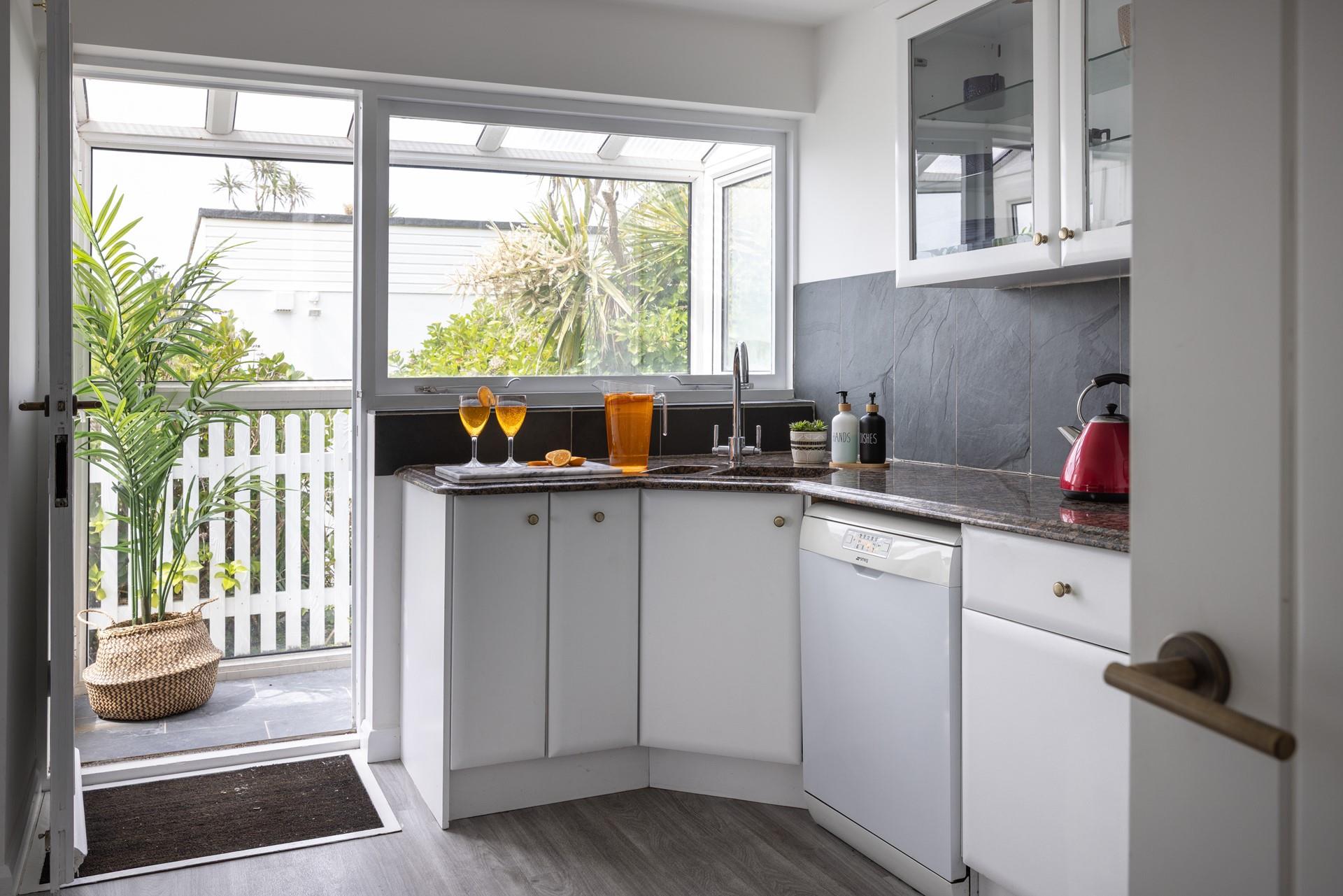 The second kitchen is well-equipped to prepare drinks and nibbles for around the pool.