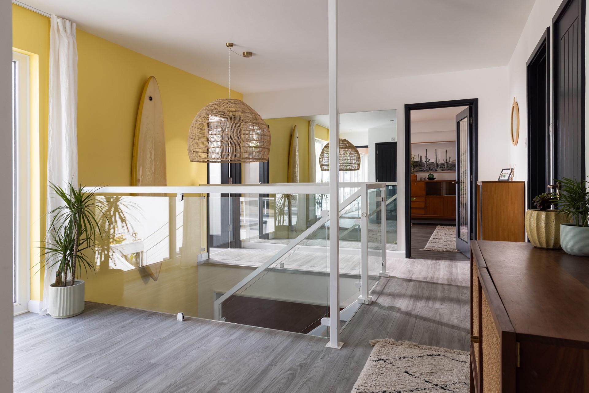 The entrance hallway features statement furnishings and leads down to the ground floor.