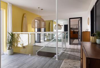 The entrance hallway features statement furnishings and leads down to the ground floor.