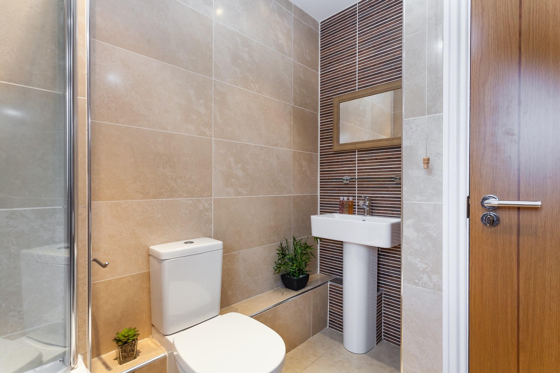 Stylish tiles give the bathroom a spa-like feel, perfect for pampering yourself.