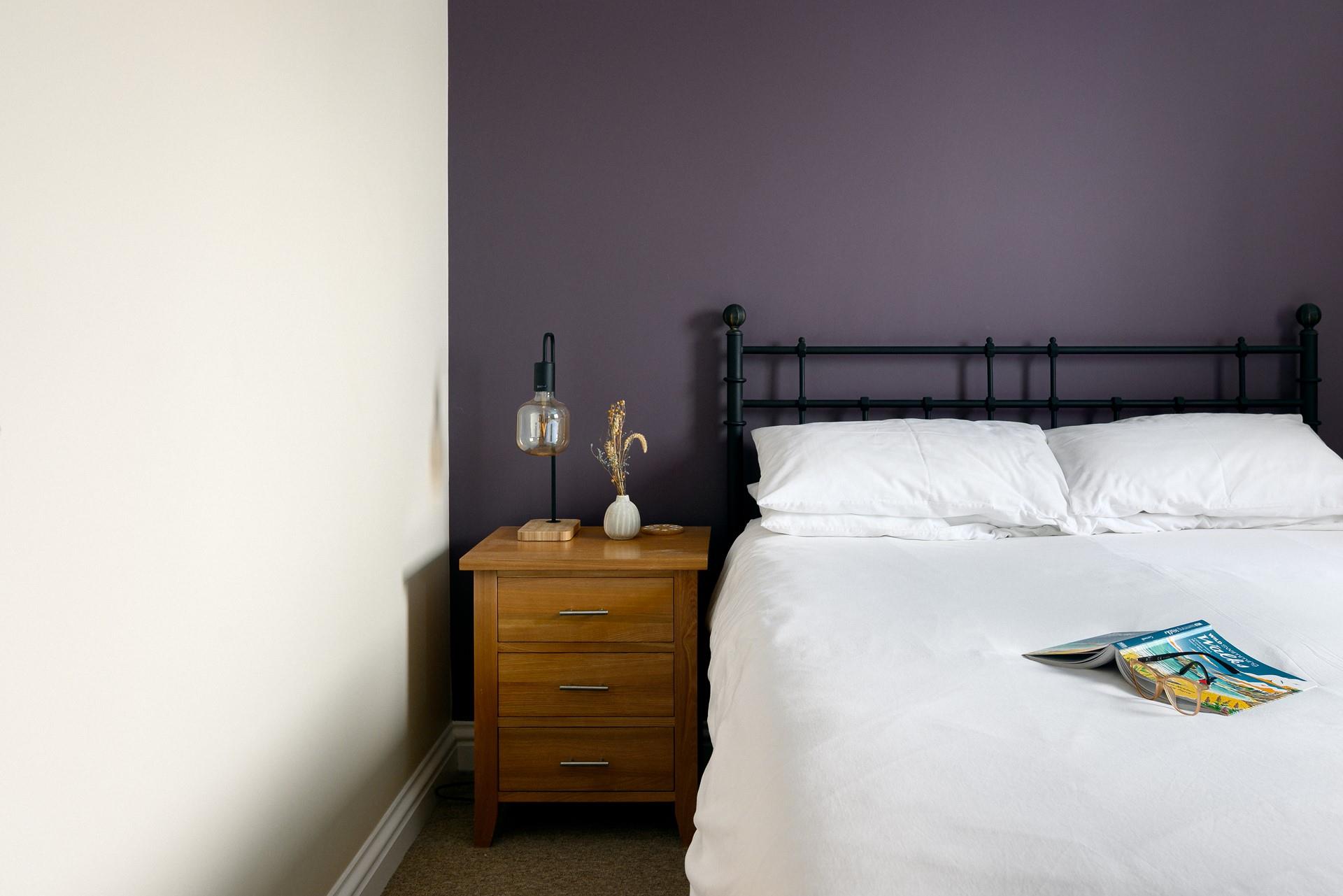 The bedroom's mix of classic furniture and rich colours make it a warm and welcoming room.