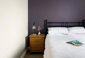 The bedroom's mix of classic furniture and rich colours make it a warm and welcoming room.