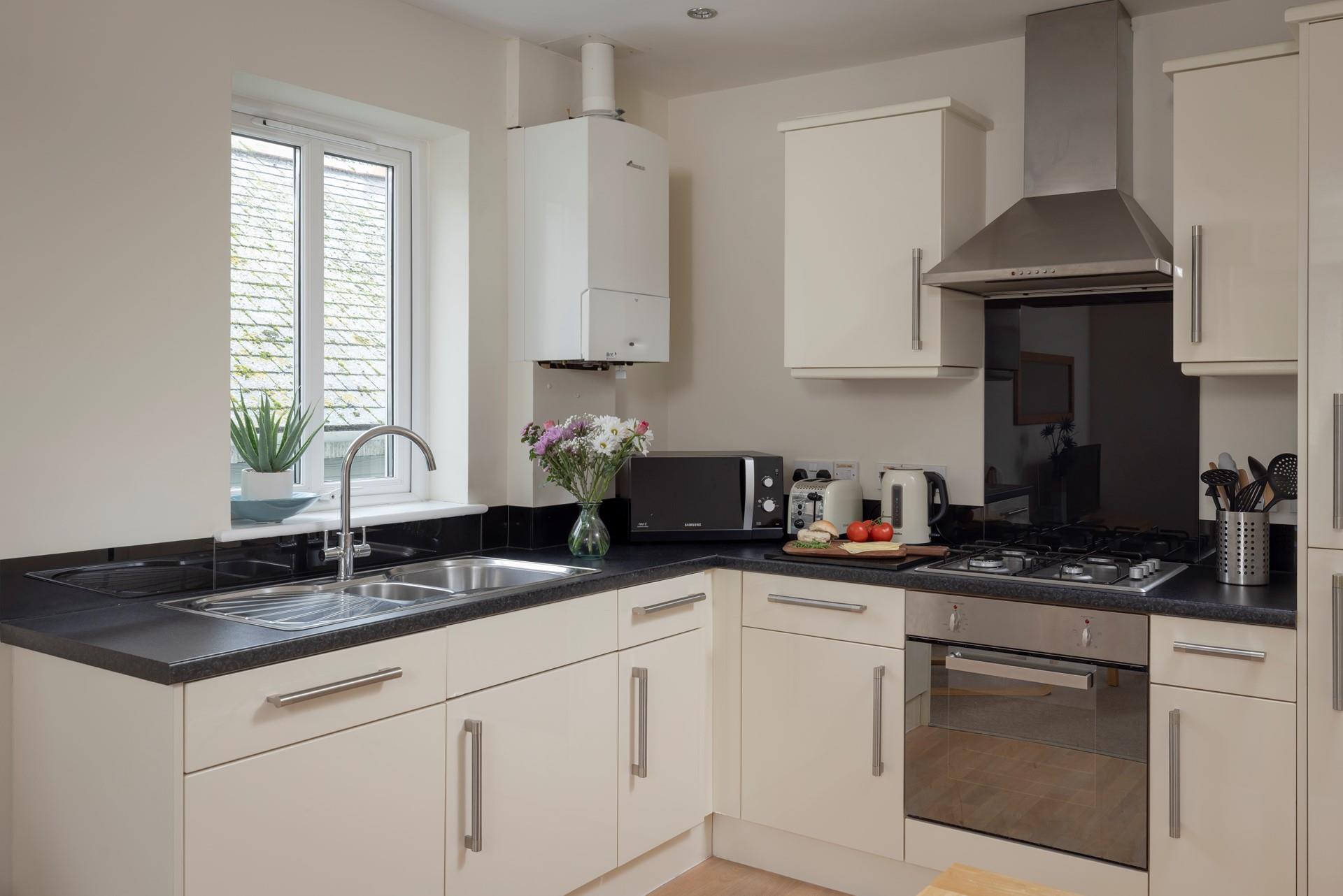 The kitchen is sleek and fully equipped with modern appliances, making it an absolute dream to cook in!