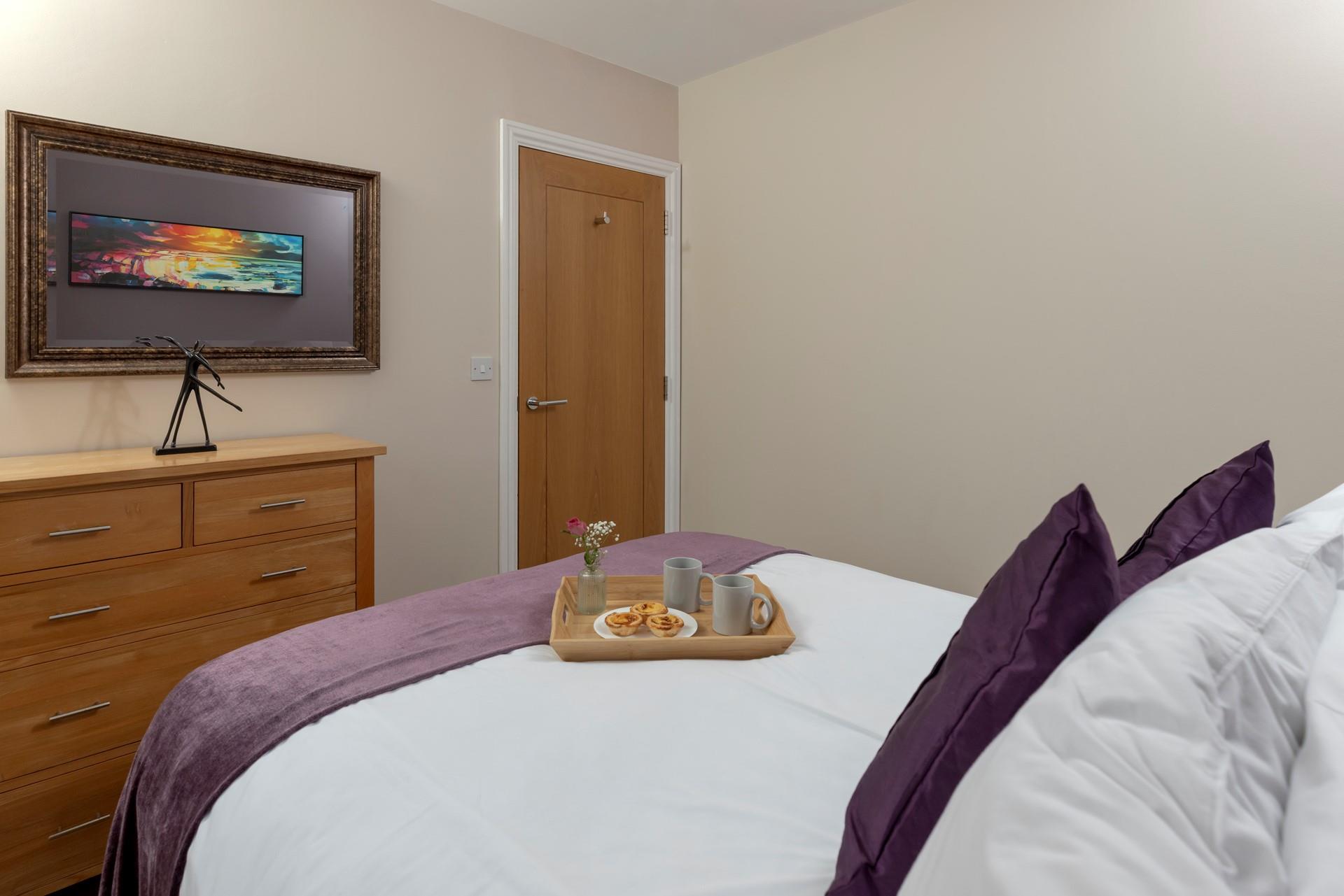 The bedroom's mix of classic furniture and rich colours make it a warm and welcoming room.