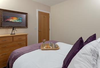 The bedroom's mix of classic furniture and rich colours make it a warm and welcoming room.