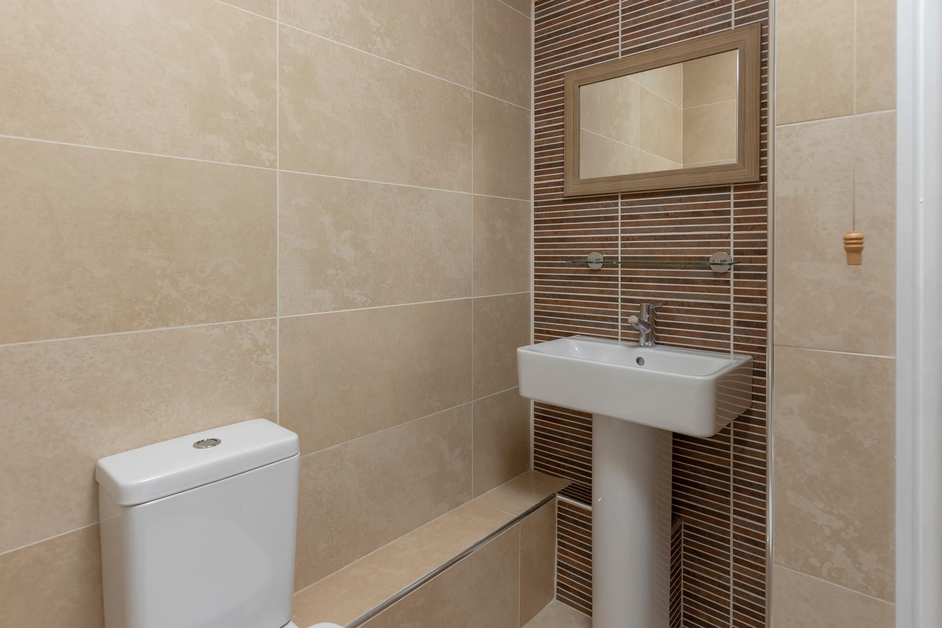 Stylish tiles give the bathroom a spa-like feel, perfect for pampering yourself.