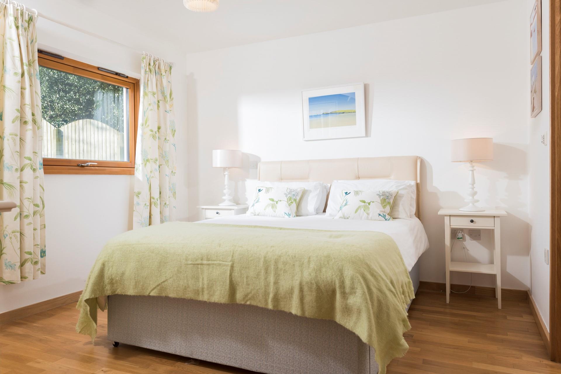 After a day exploring Falmouth, unwind in the master bedroom where pastel tones and a comfortable bed will lull you to sleep.