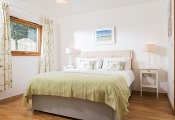 After a day exploring Falmouth, unwind in the master bedroom where pastel tones and a comfortable bed will lull you to sleep.