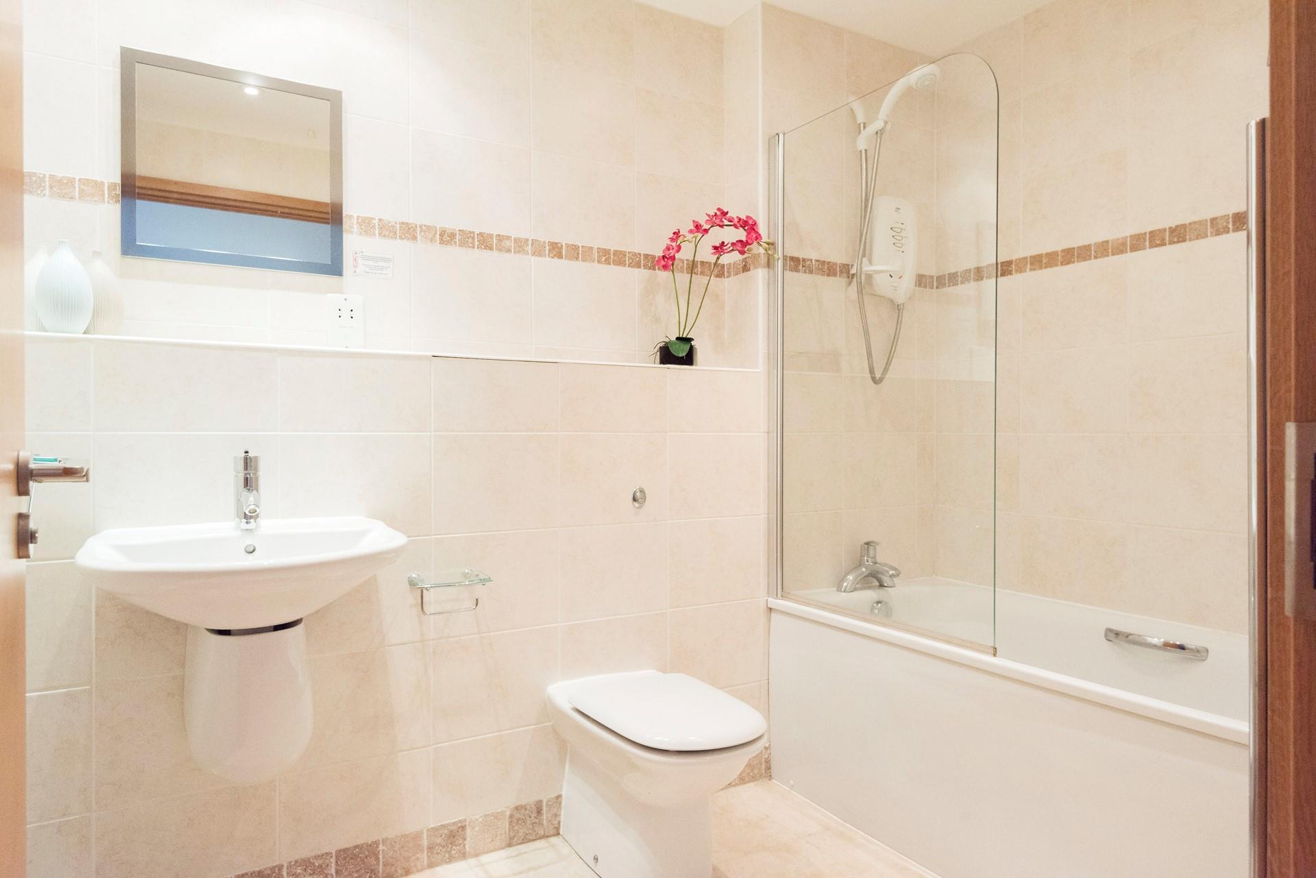 The family bathroom benefits from a bath, perfect for those long evening soaks after a day relaxing on the beach.