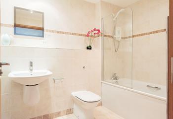 The family bathroom benefits from a bath, perfect for those long evening soaks after a day relaxing on the beach.