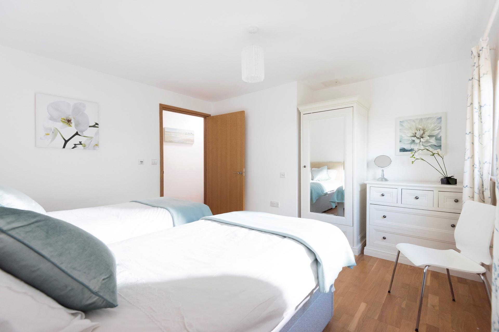 Turquoise and cream decor create a calming oasis, the perfect room to relax and drift off to sleep in.