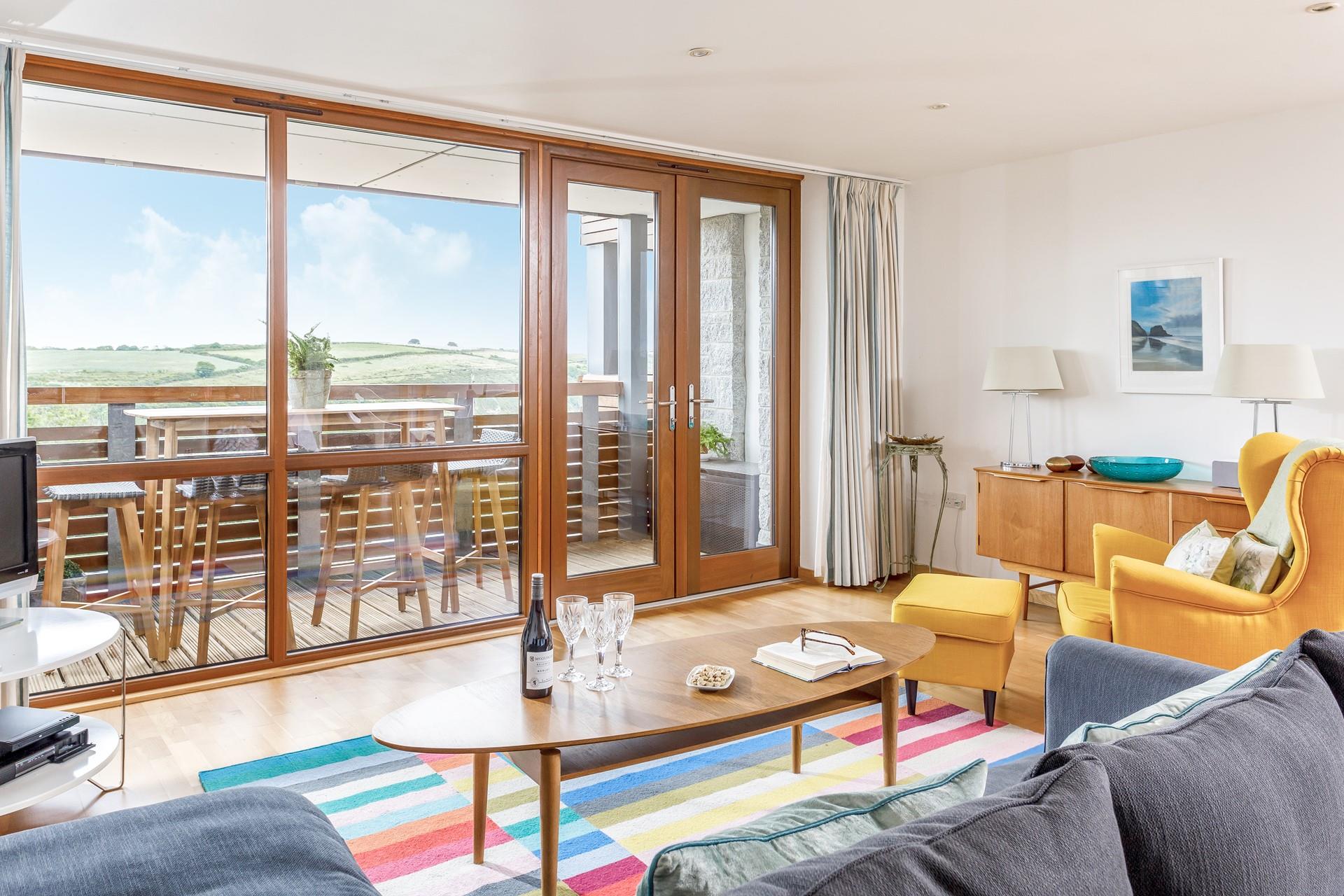Bright tones, large windows and balcony doors have created a bright and airy living space.